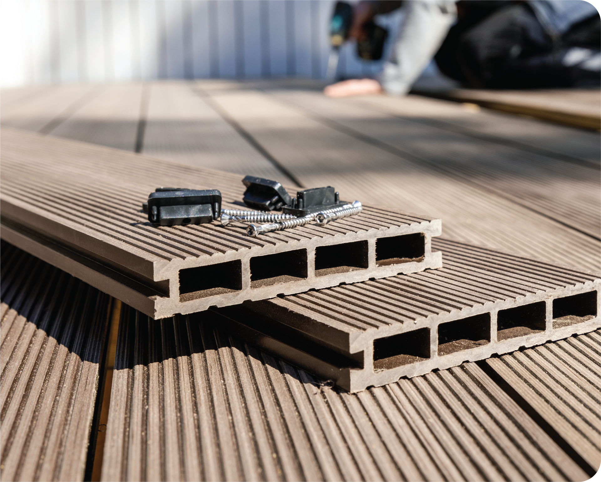 Two pieces of wood are sitting on top of each other on a wooden deck.