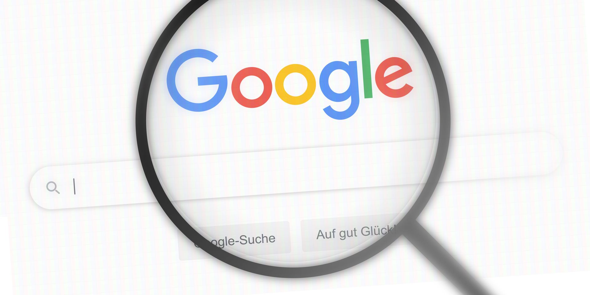 A magnifying glass is looking at a google search page.