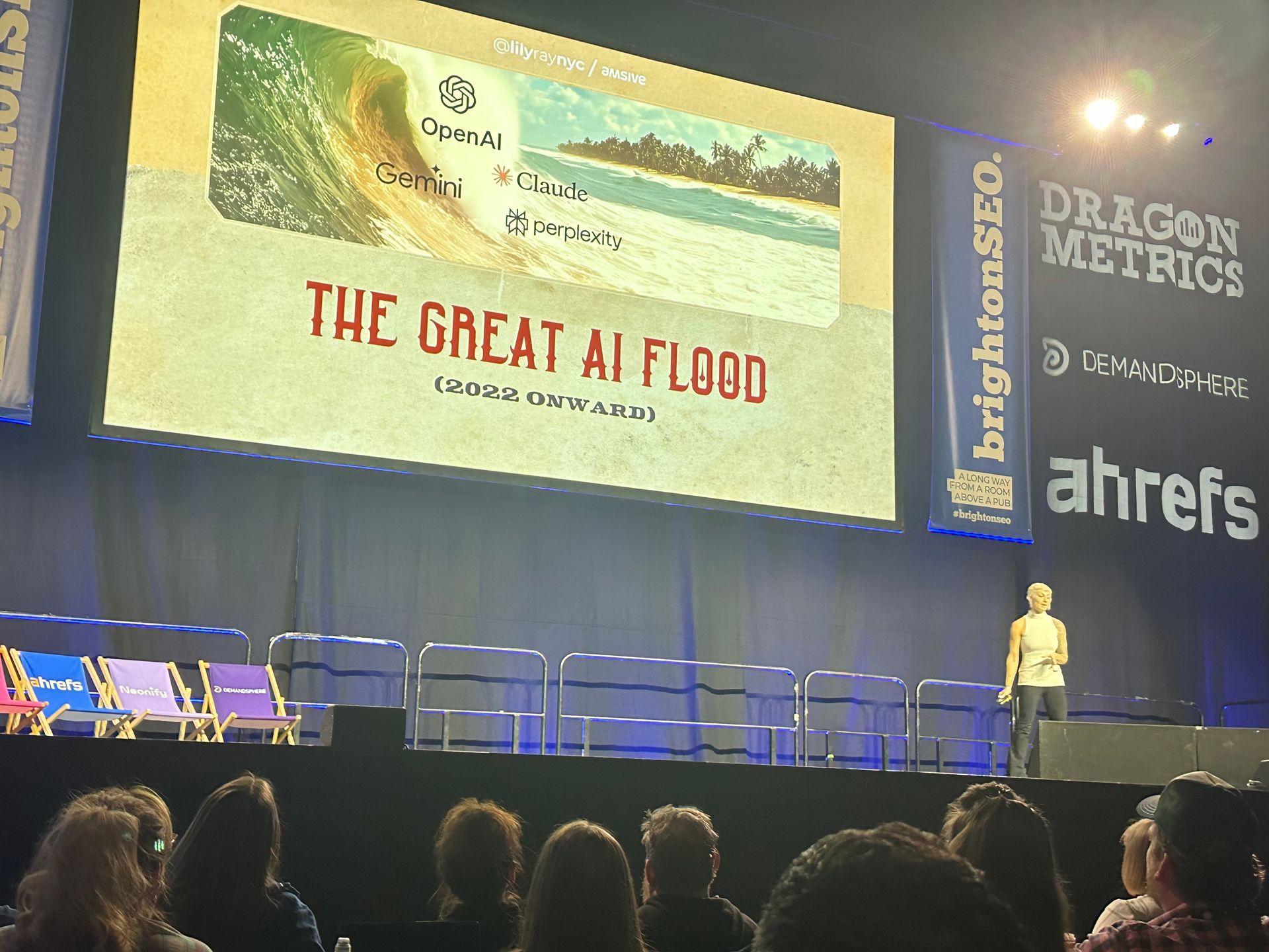 A speaker on stage presents 