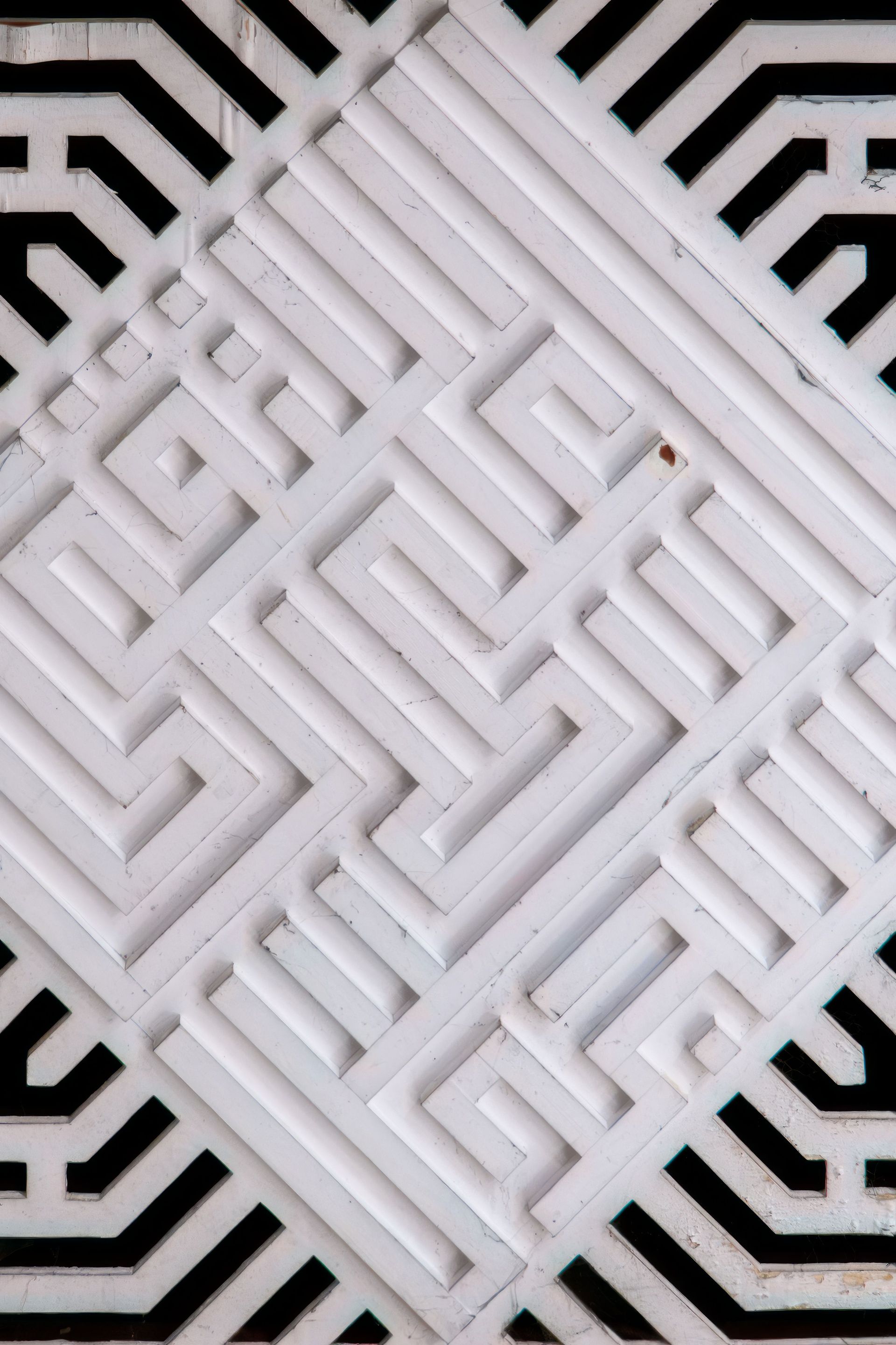 White geometric lattice pattern with diagonal woven lines and black border accents