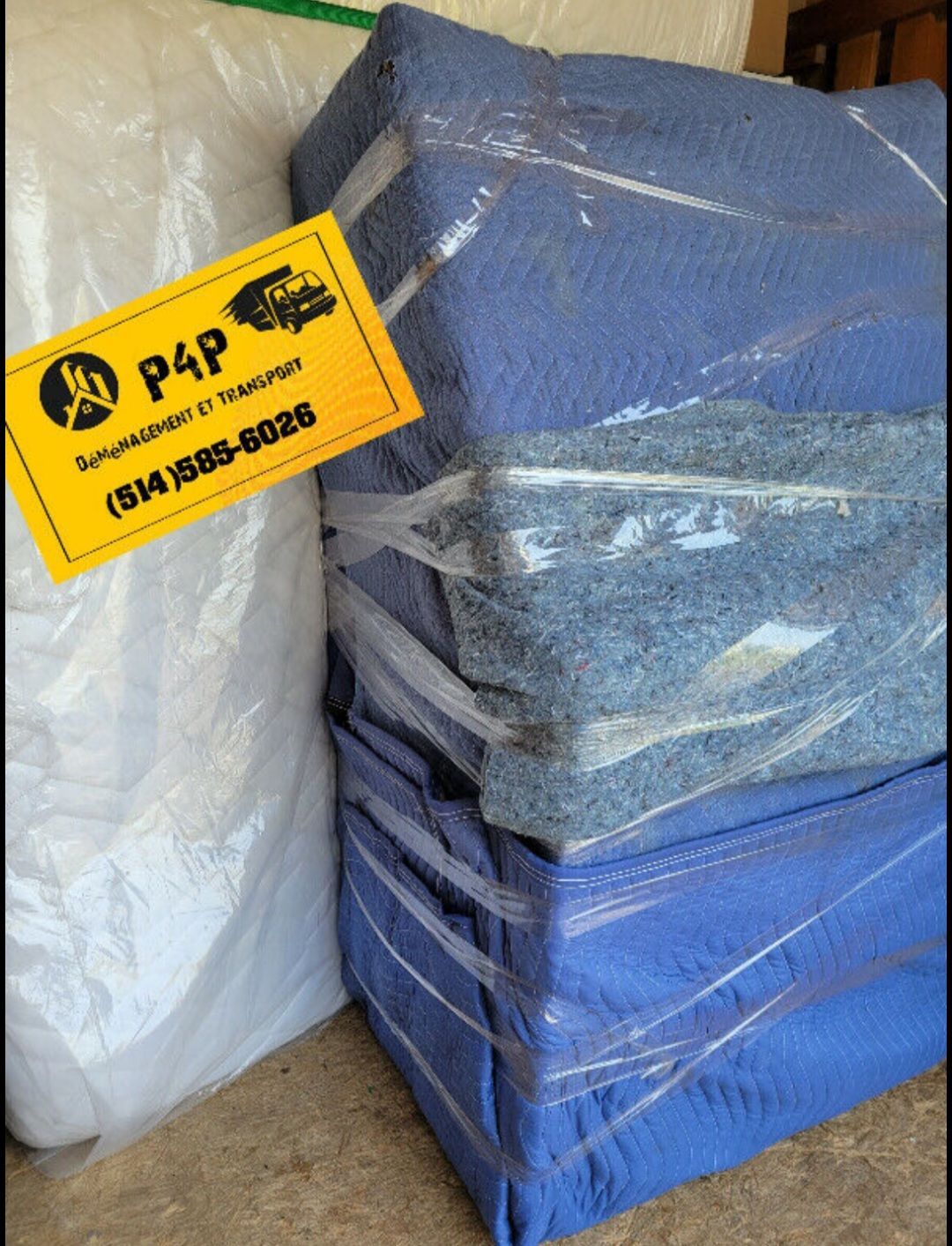 A stack of blue blankets wrapped in plastic with a yellow sign that says p4p