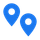 Deux épingles de carte bleues avec un cercle blanc au milieu sur fond blanc.