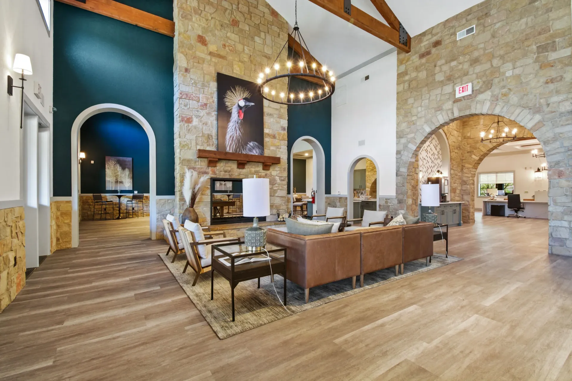 Modern kitchen with island, stone archway, and bar stools.