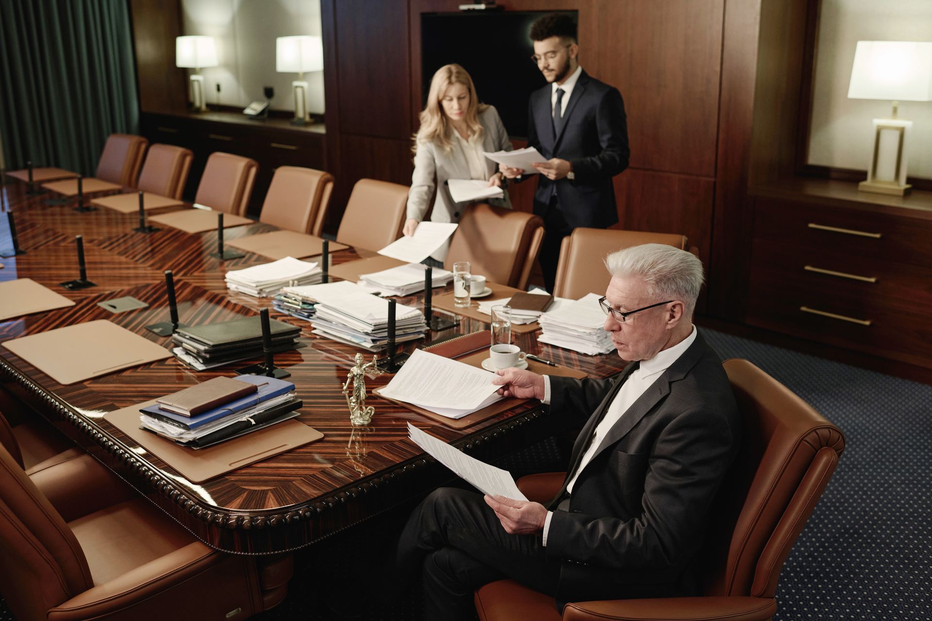 A group of people are sitting around a conference table.