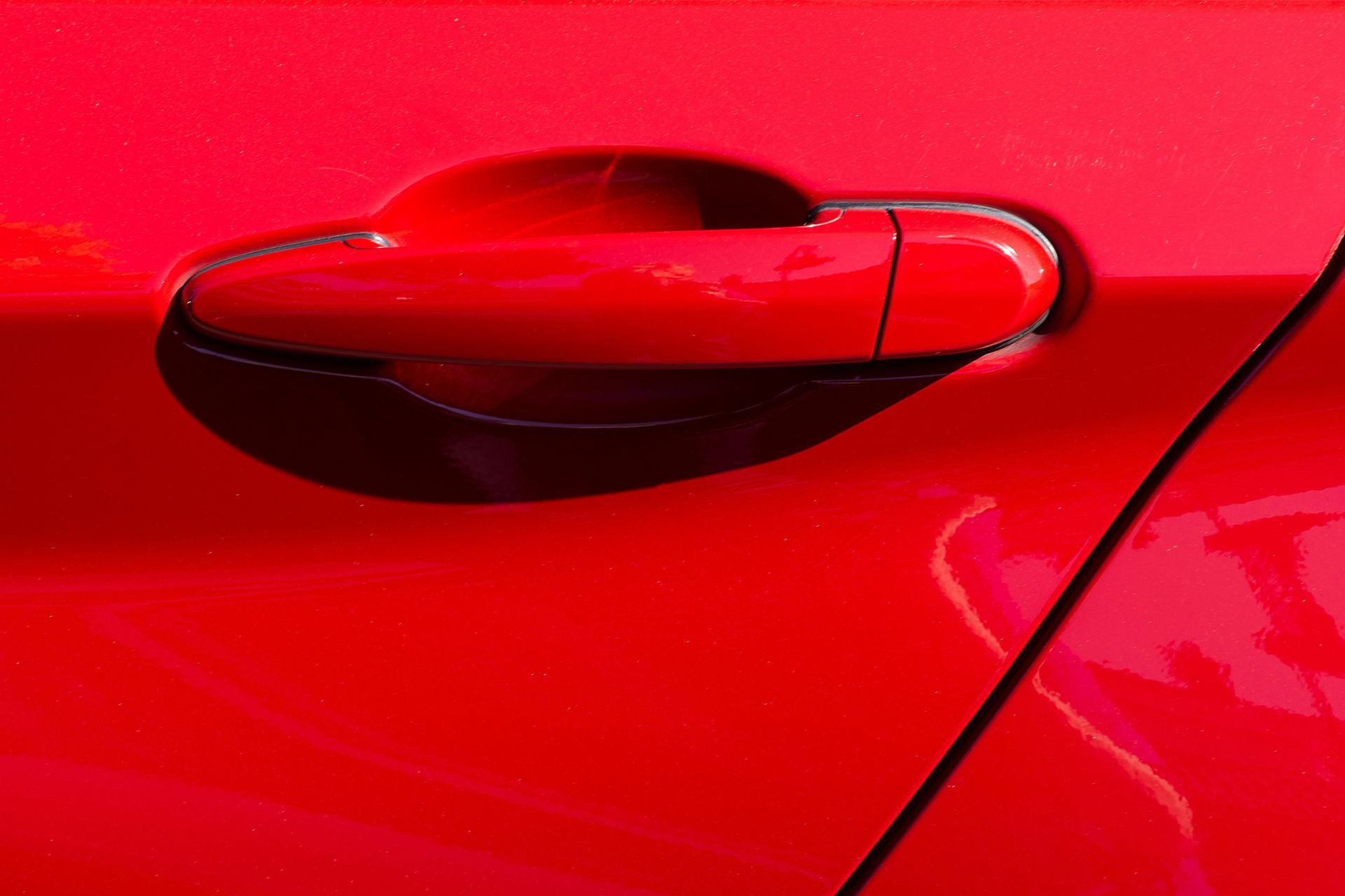 A close up of a red car door handle