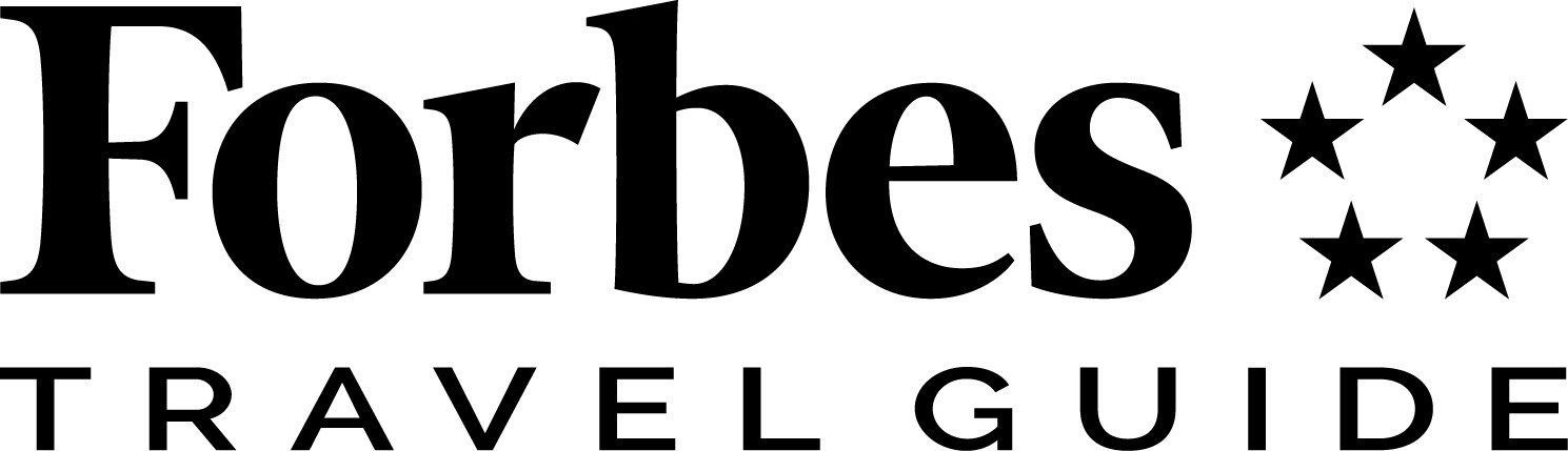 The forbes travel guide logo is black and white with stars.