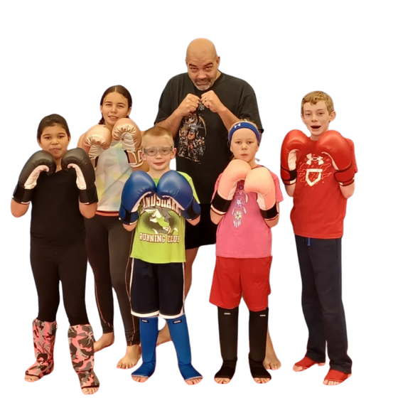a group of children are practicing martial arts together .