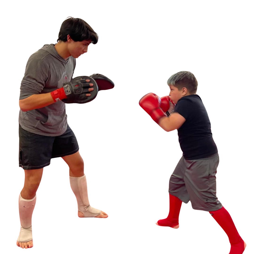 A boy and two girls are wearing karate uniforms and pointing at the camera
