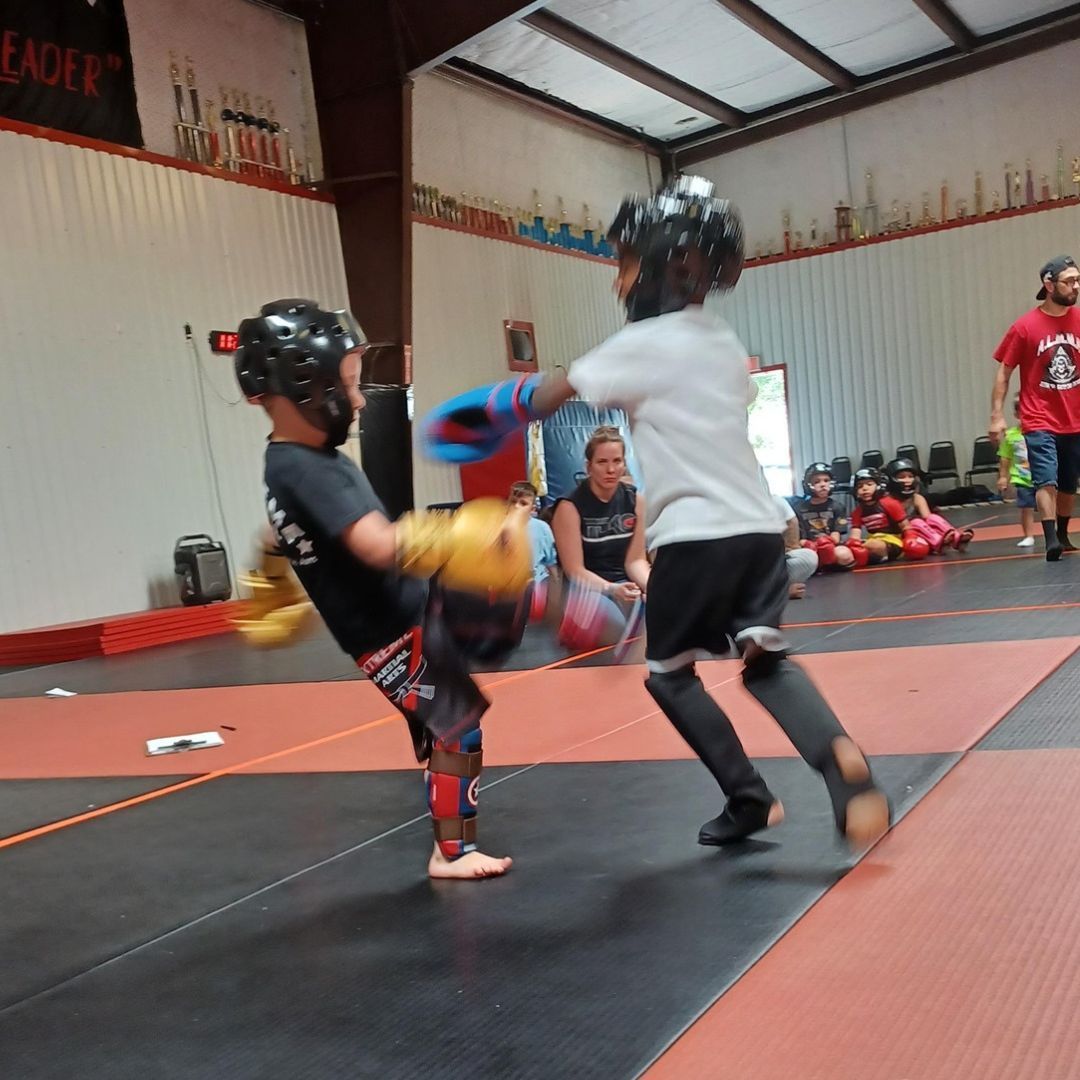 A boy and a girl are practicing taekwondo together.