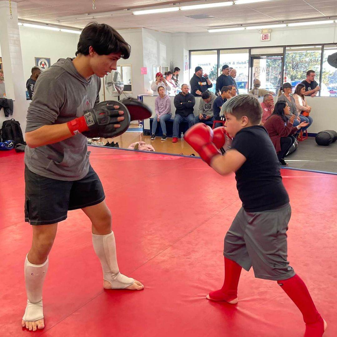 A boy and a girl are practicing taekwondo together.