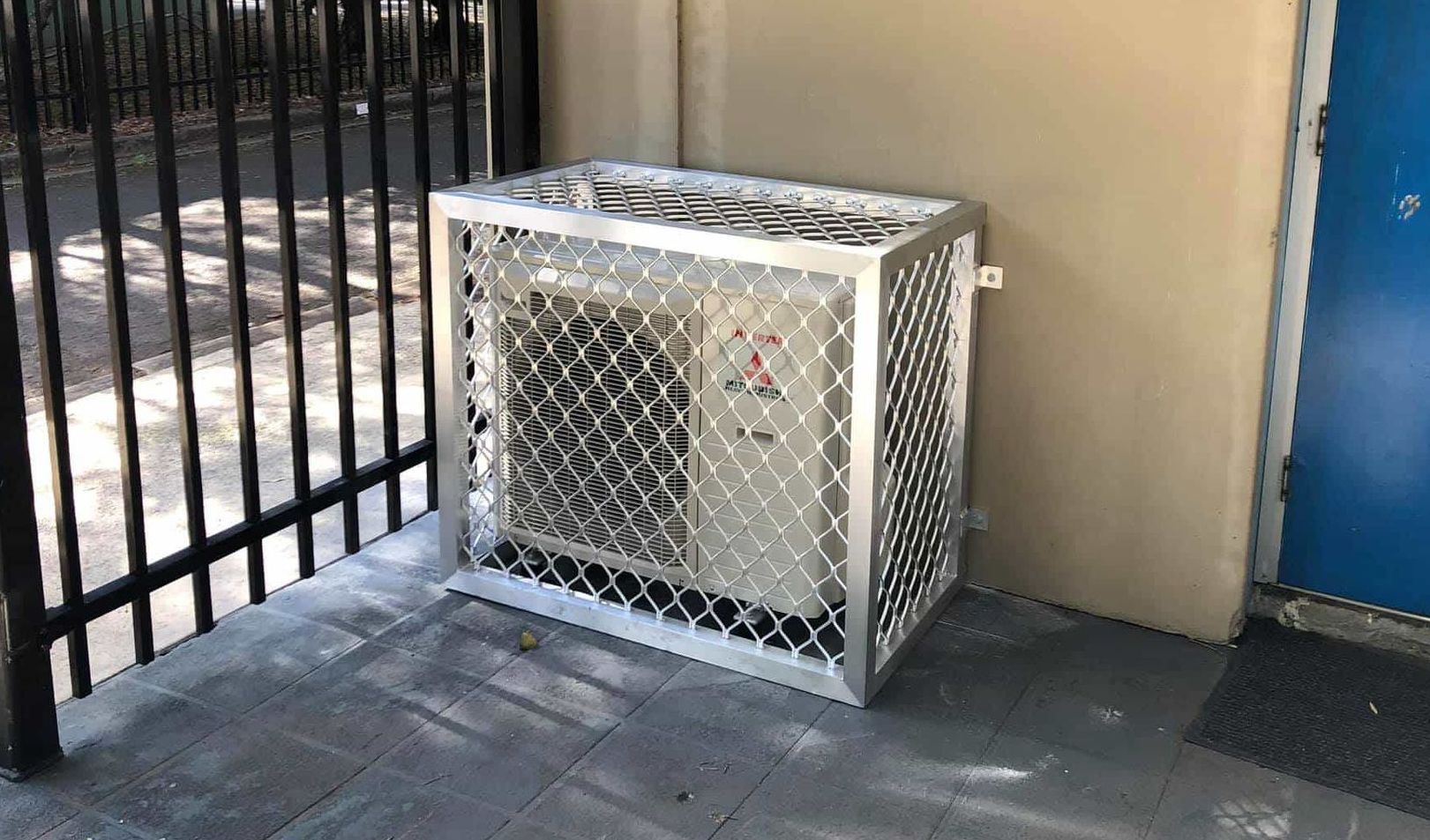 A Man is Repairing an Air Conditioner on the Floor — Steve's Air Conditioning in Dapto, NSW