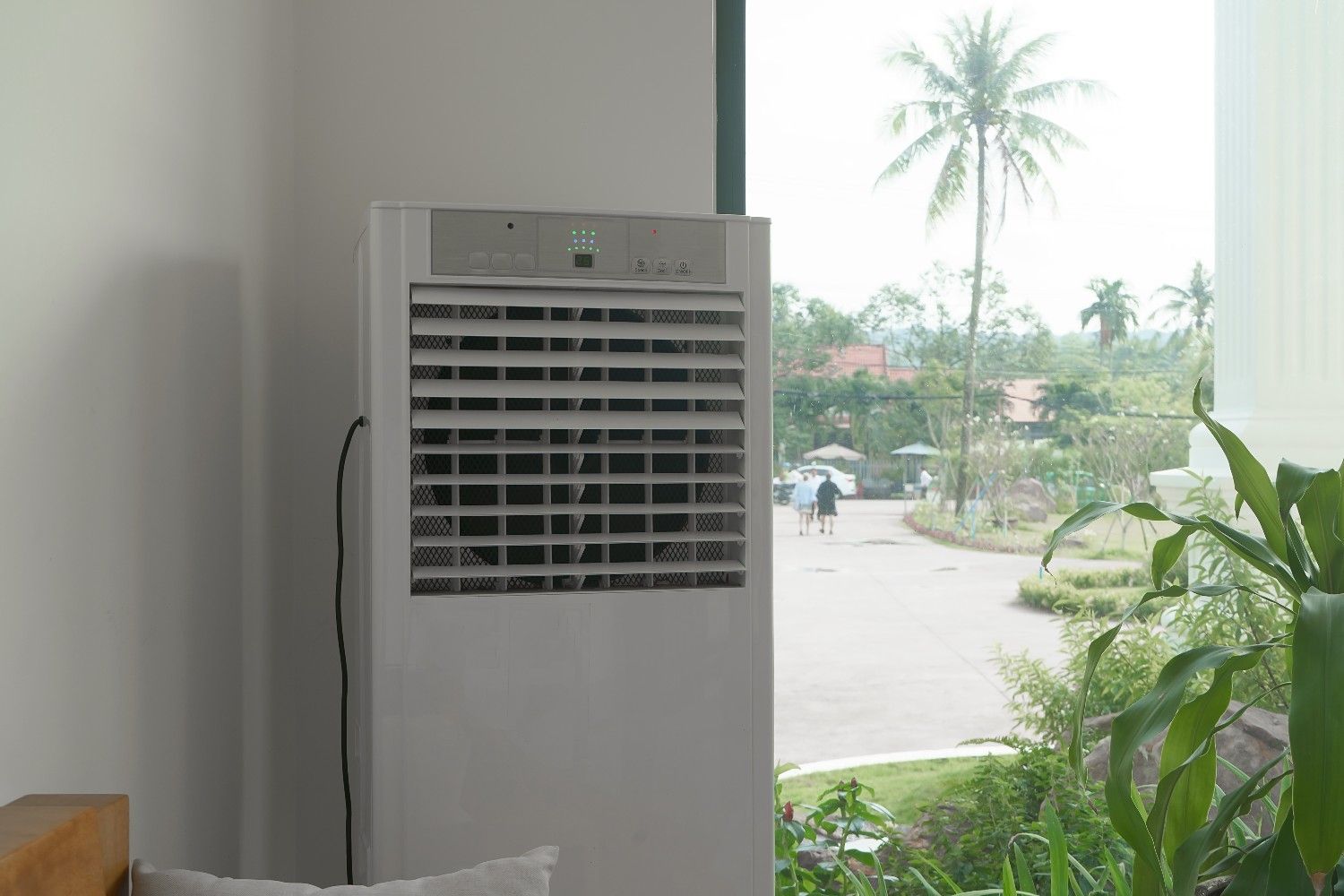 A White Air Cooler Next to A Window — Magneto HVAC in Port Douglas, QLD