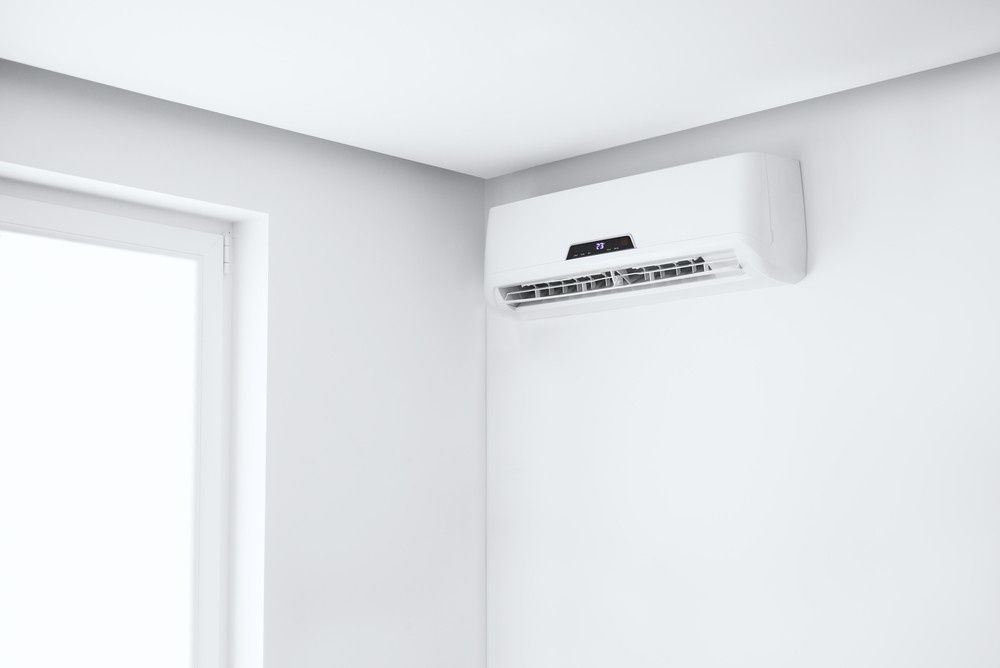 A Mounted Air Conditioner in A Bright Room Corner — Magneto HVAC in Cassowary Coast, QLD