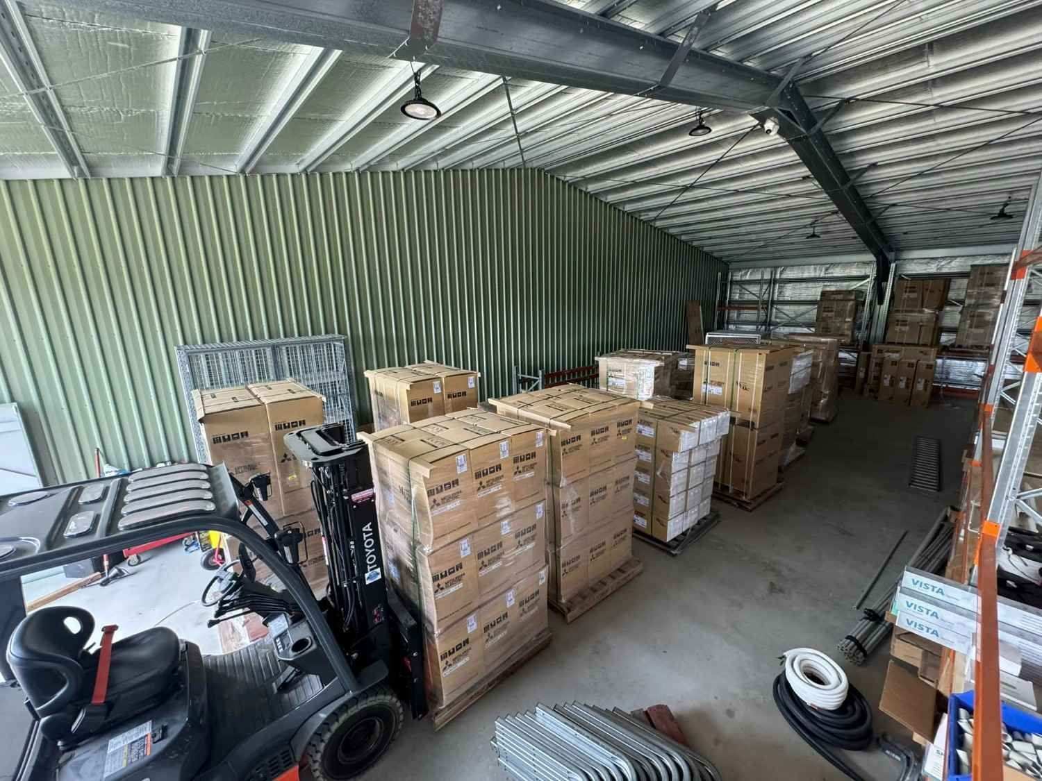 A Forklift Unloading Boxes in A Warehouse — Magneto HVAC in Cassowary Coast, QLD