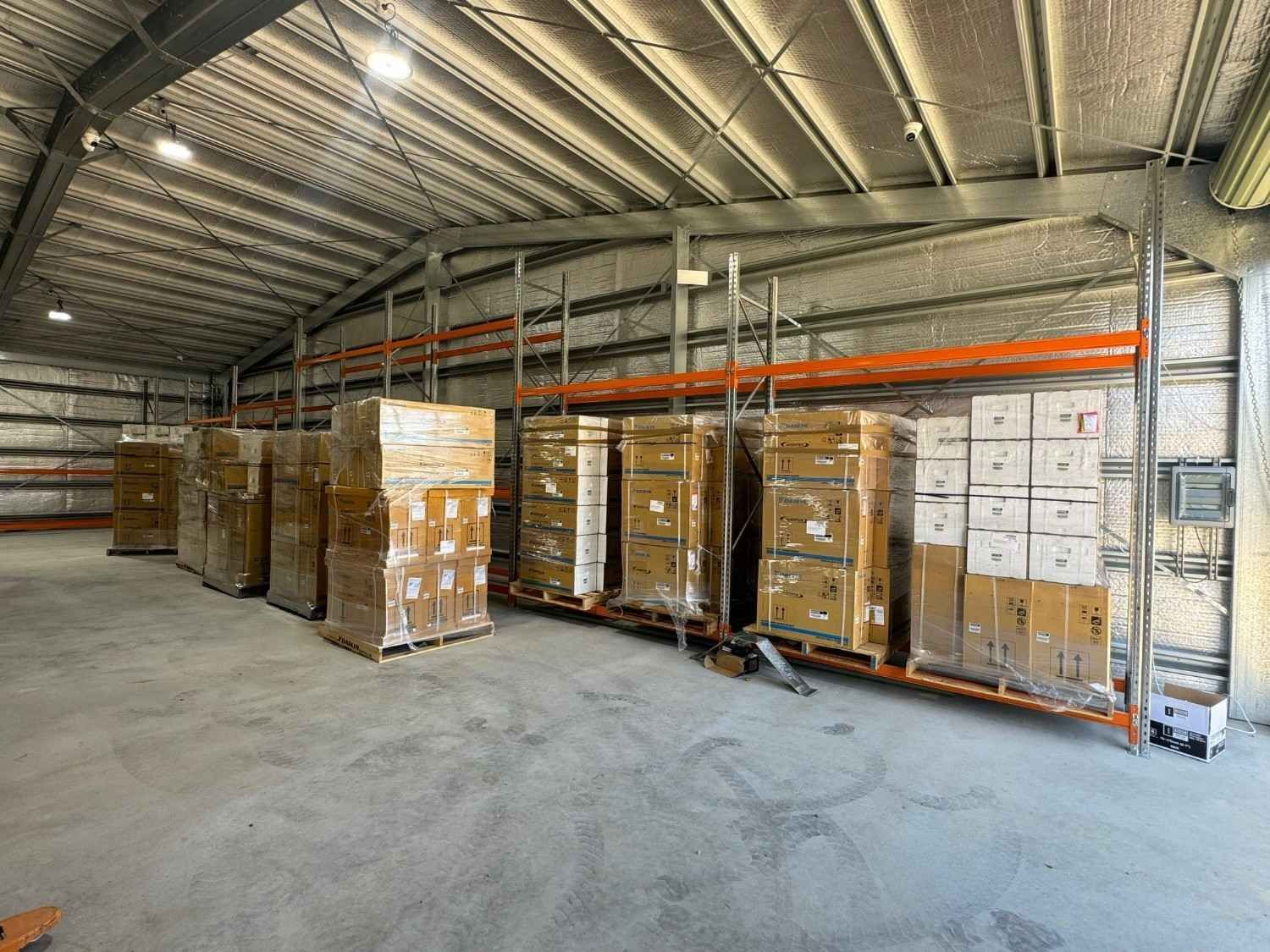 Warehouse interior with stacked boxes on pallets — Magneto HVAC in Portsmith, QLD