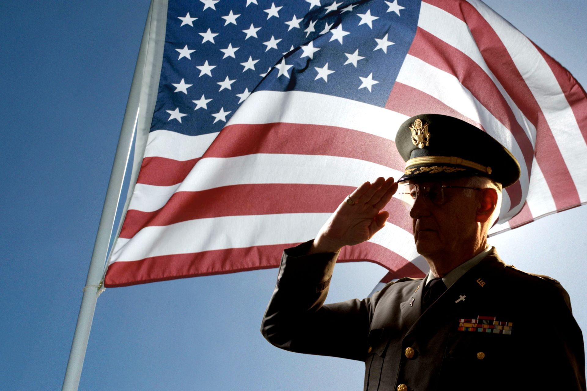 A close up of a military uniform with medals and ribbons on it.