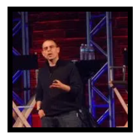 A man is standing on a stage giving a speech.