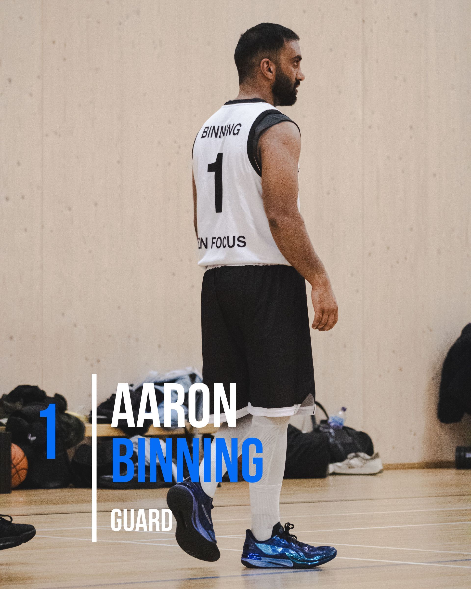 Basketball player Aaron Birning wearing jersey number 1, standing on a court.