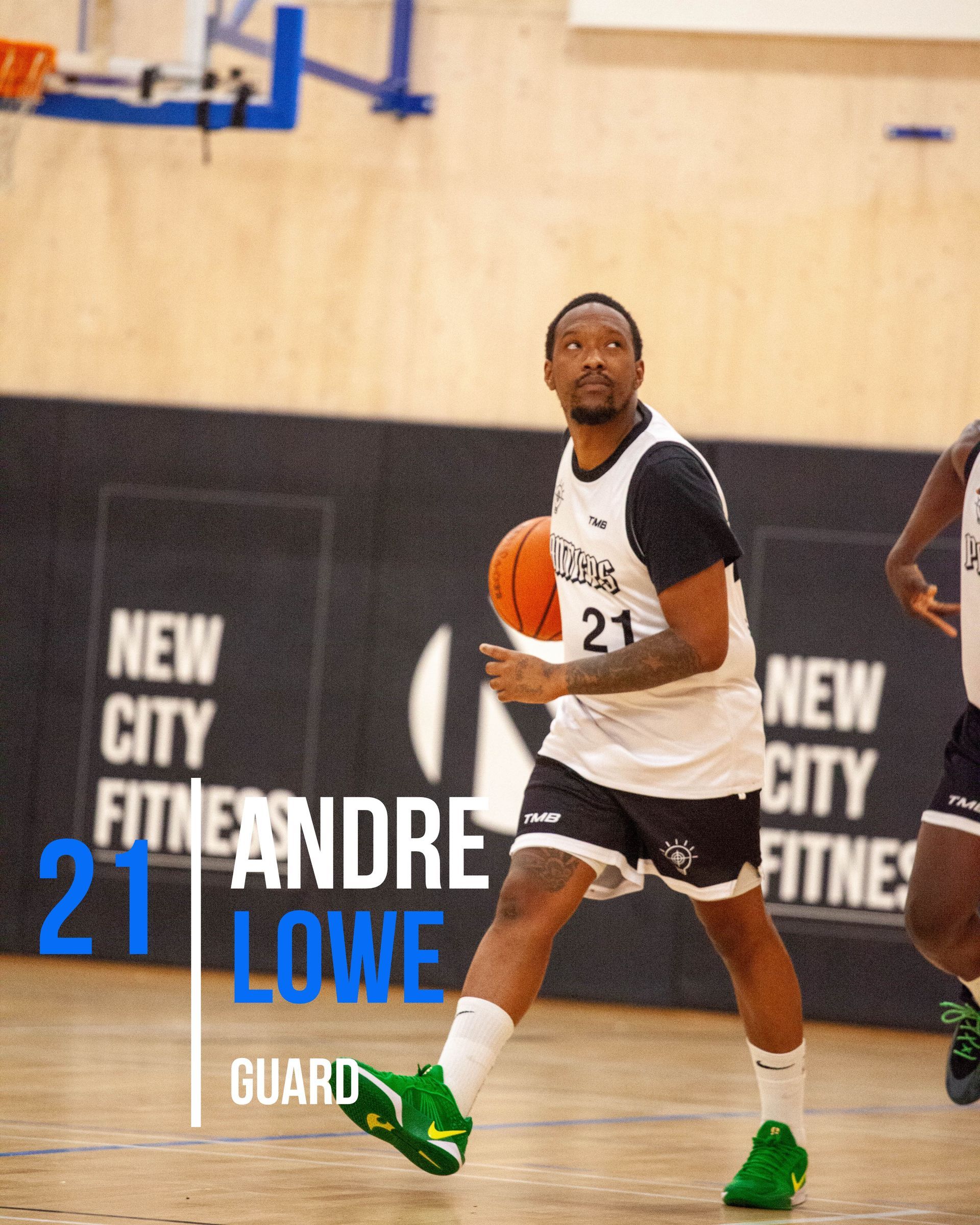 Basketball player Andre Lowe dribbles the ball on a court; he wears a jersey with the number 21 and green shoes.