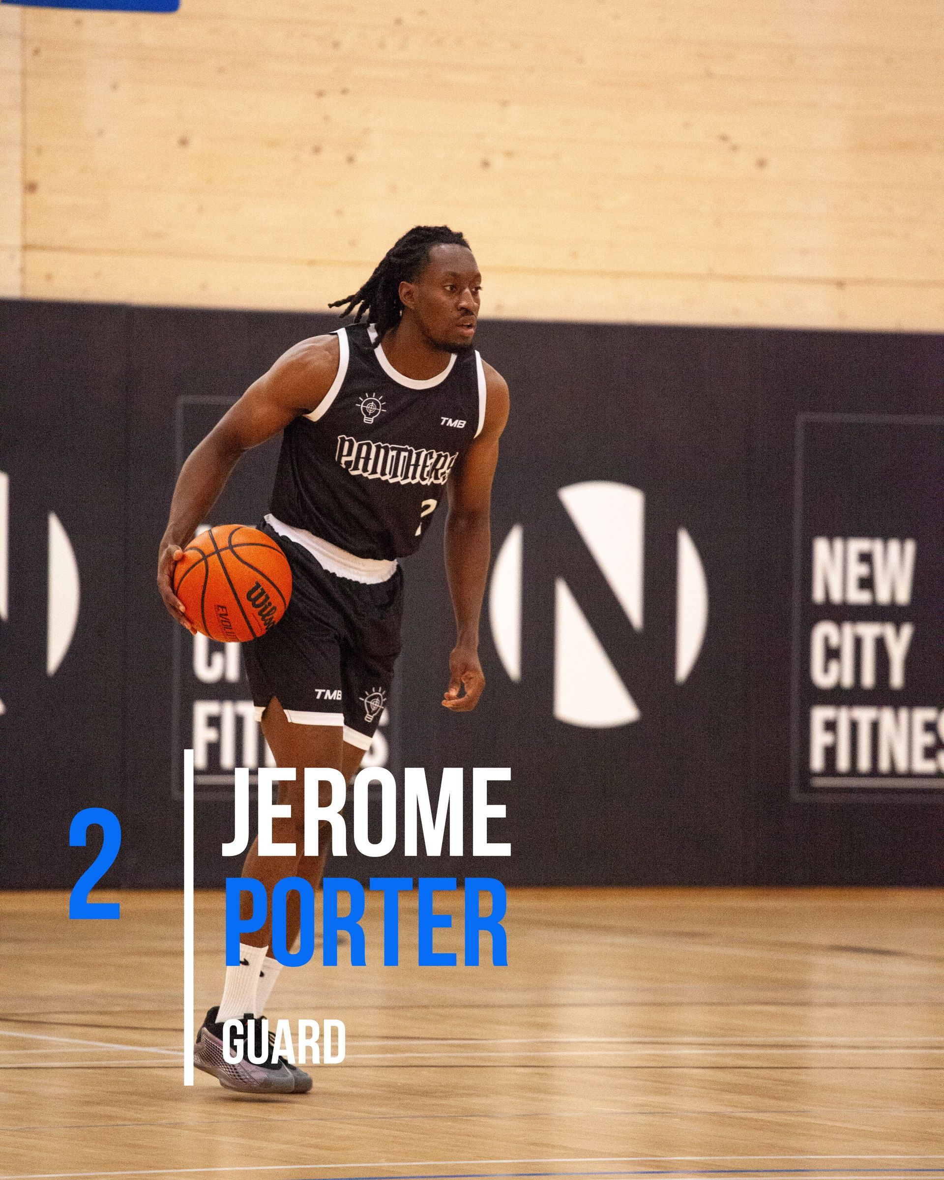 Basketball player, Jerome Porter, dribbling on court. He wears a black jersey with white text.