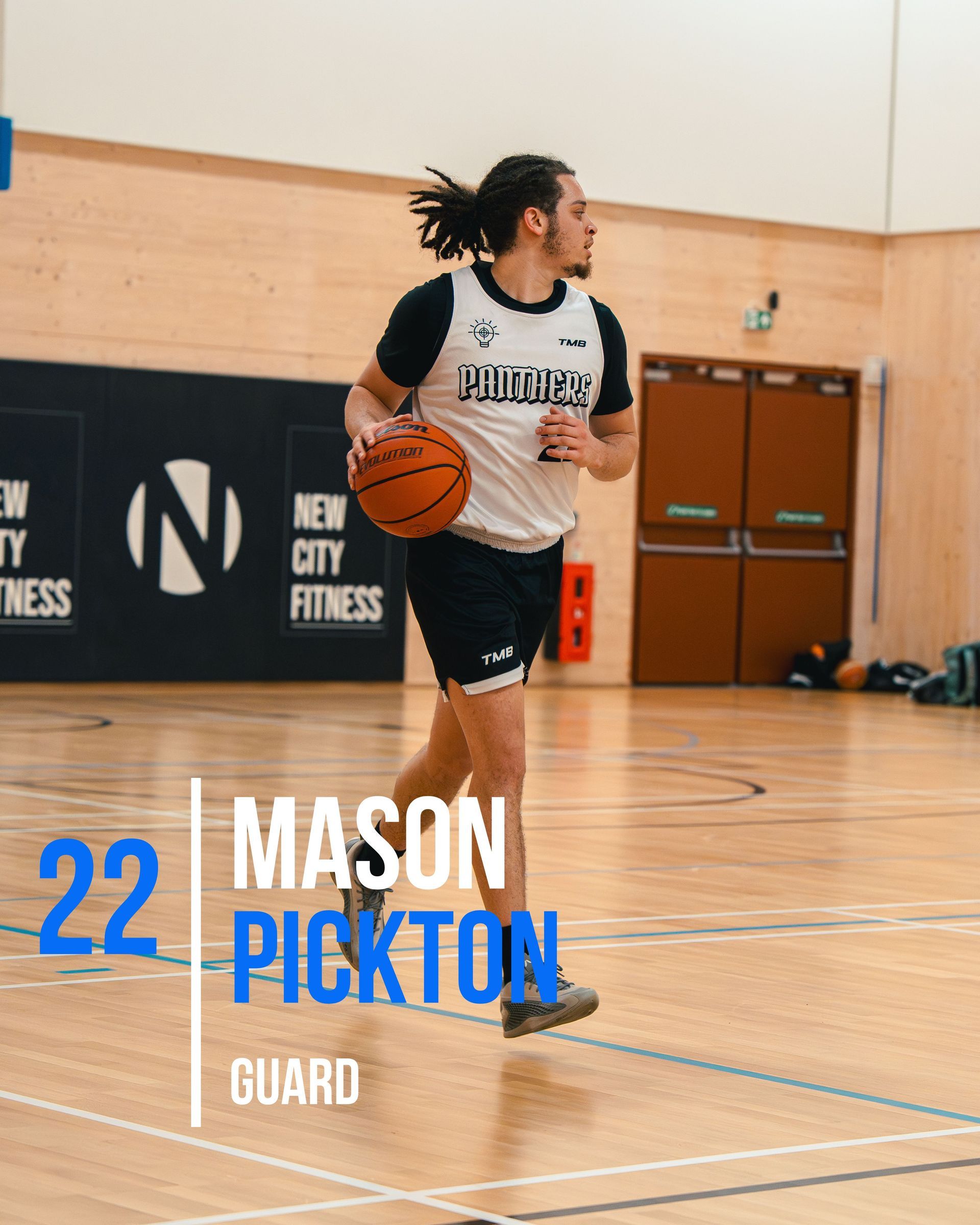 Basketball player Mason Pickton in a gymnasium, dribbling the ball.