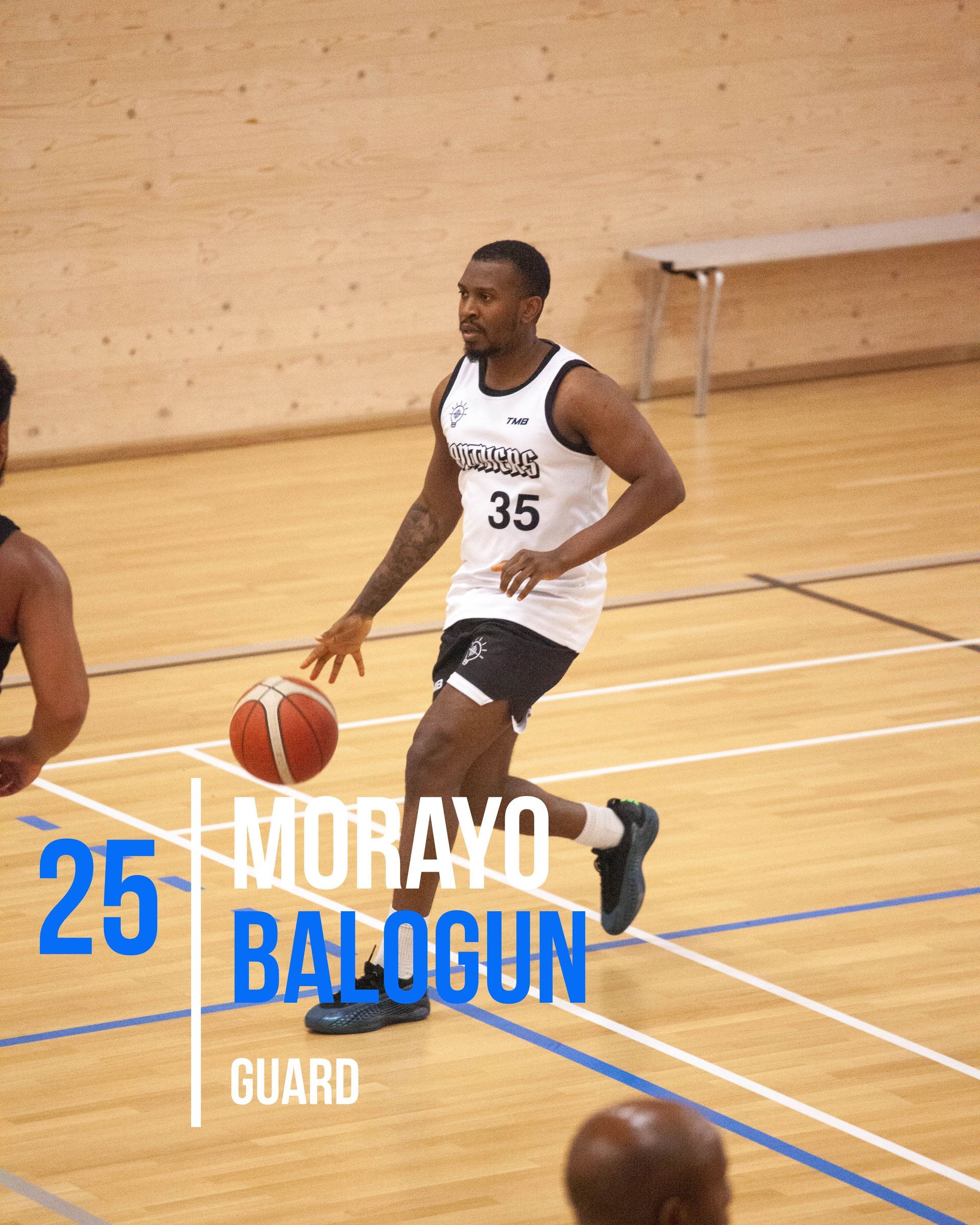 Basketball player Morayo Balogun dribbling the ball; wears Panthers jersey; standing in a gym.