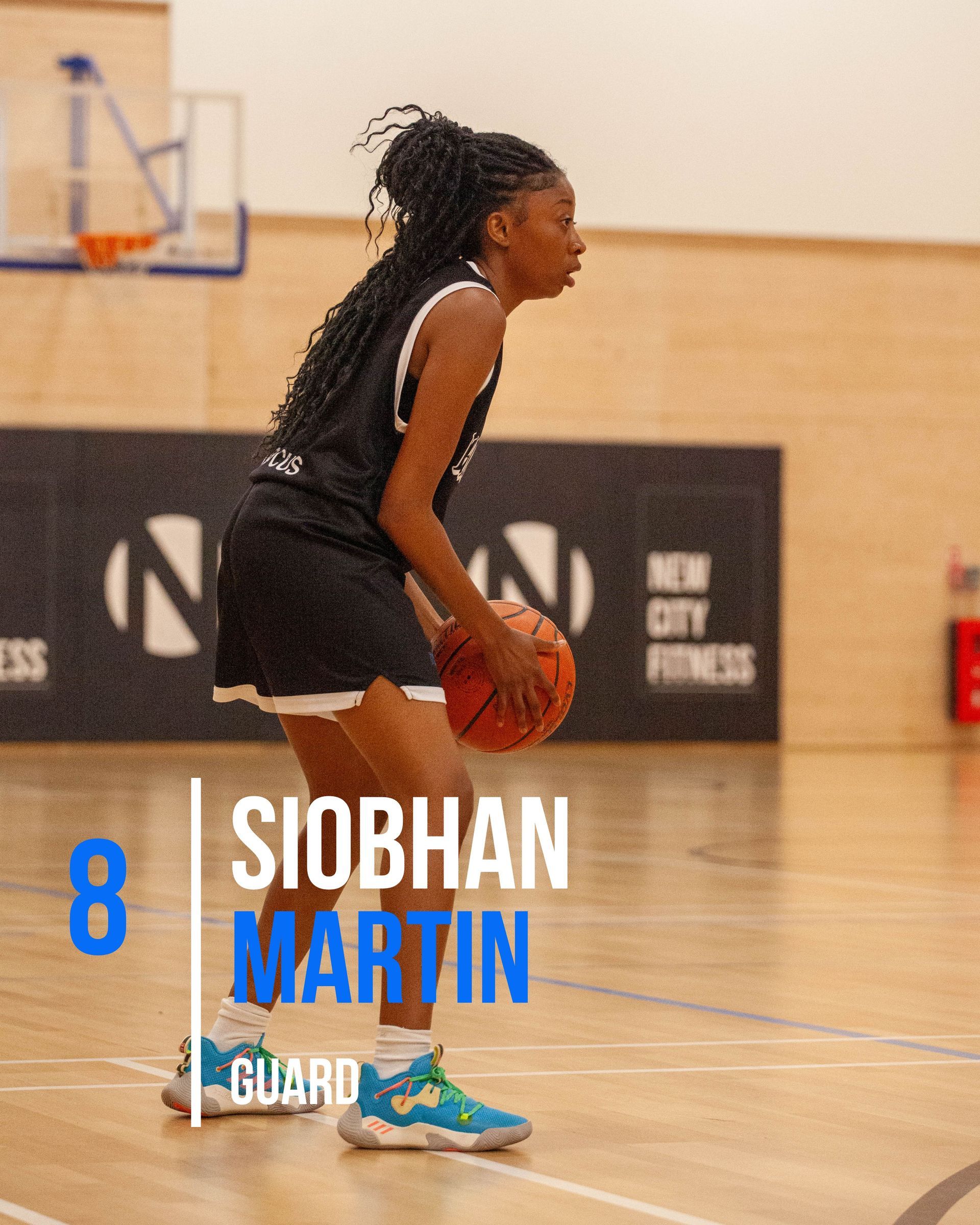 Basketball player Kiera Williams in a blue uniform, holding the ball, preparing to play on the court.