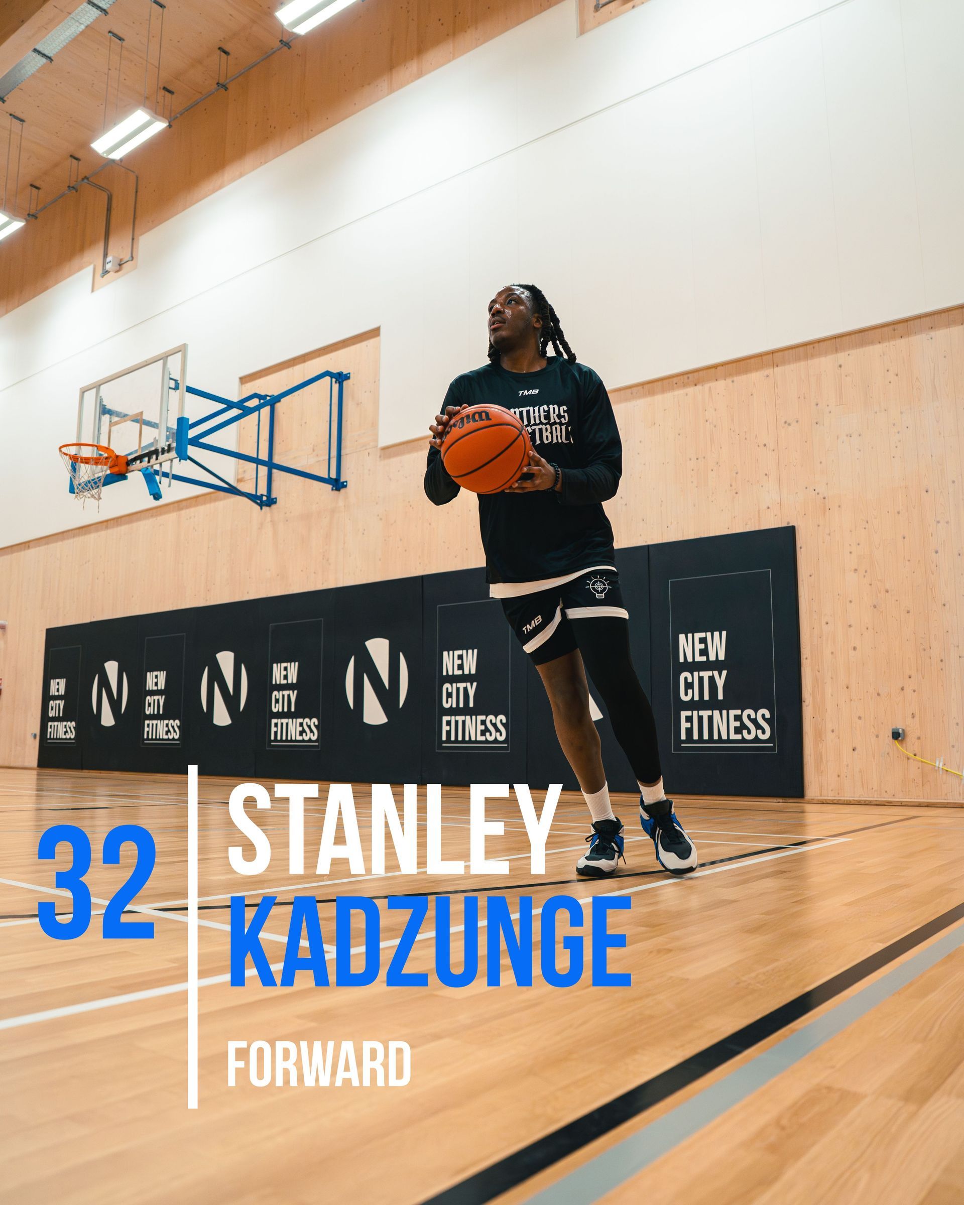 Basketball player Stanley Kadzunge holding ball on court.