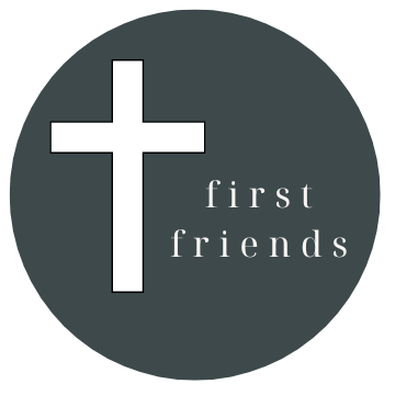 White cross and “first friends” text on a dark gray circle logo