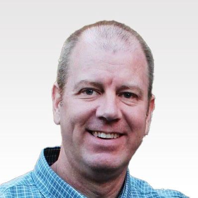 Smiling man in a blue checkered shirt on a white background