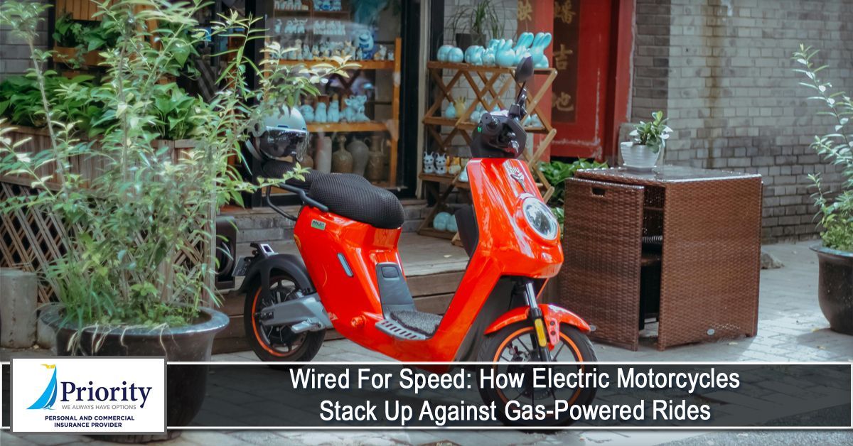Orange electric scooter parked near potted plants and a wooden structure.