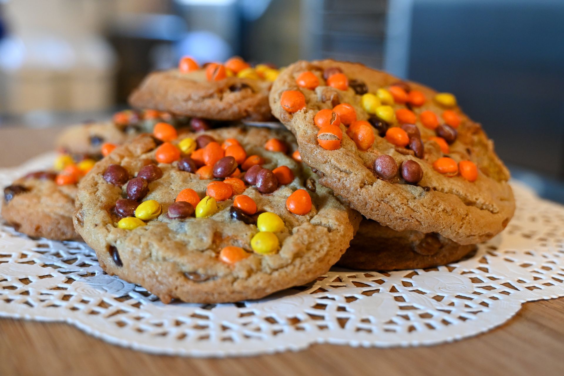 A stack of peanut butter and jelly cookies on a napkin on a table.