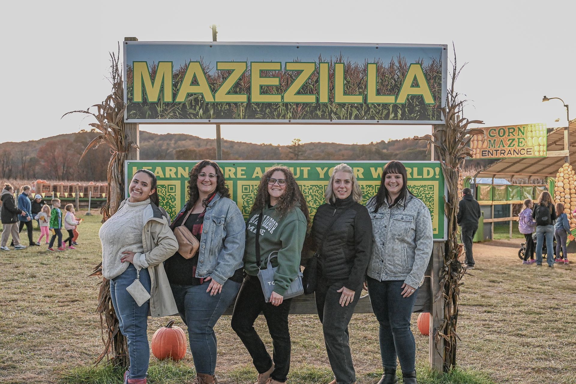 Five women posing in front of a 