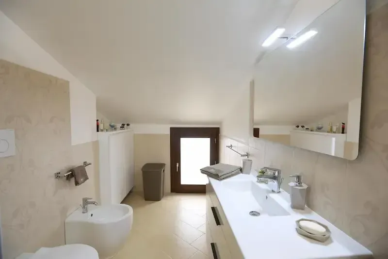 Contemporary bathroom with shower enclosure, bidet and coordinated tile design