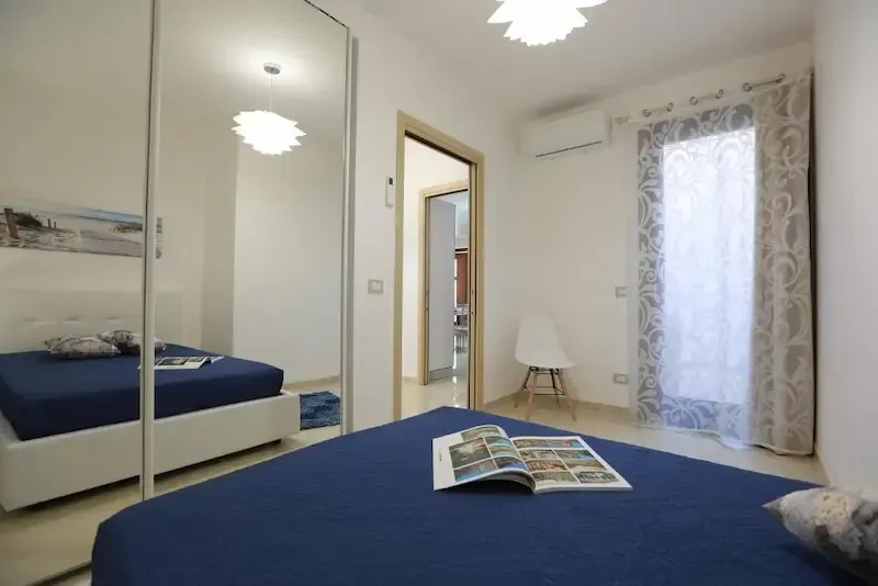 Double bedroom with large wardrobe and warm lighting