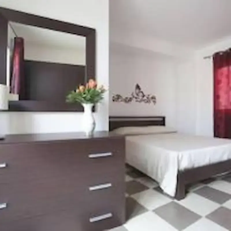 Casa Nina Pozzallo bedroom with double bed and modern interior design