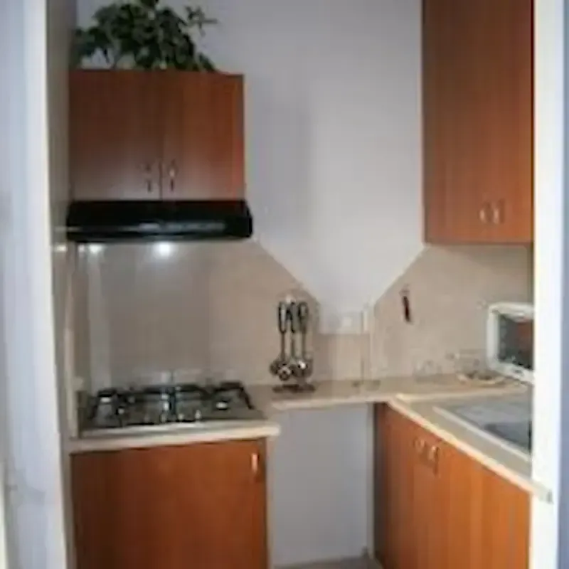 Casa Nina Pozzallo small kitchen with stove, cabinets and cooking essentials