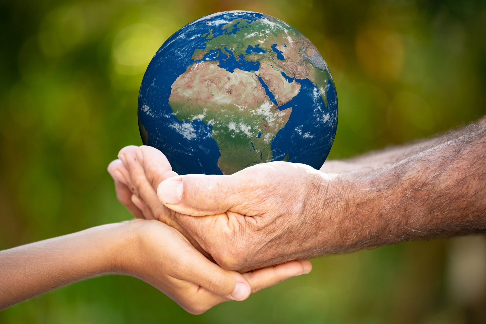 Two hands holding a miniature Planet Earth