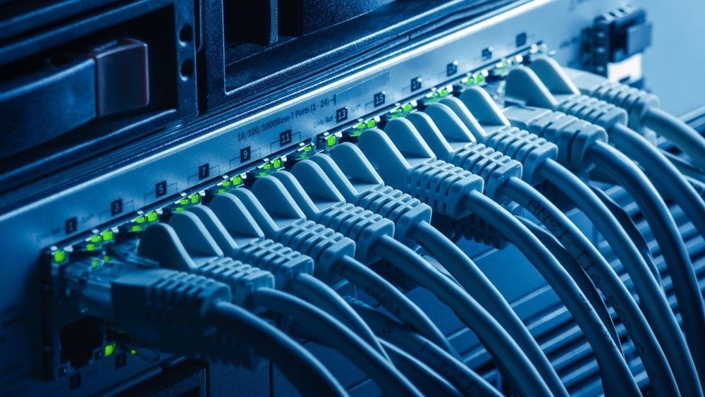 Server Rack With Ethernet Cables Plugged in, Lit With Blue Hue — Robert Coony Electrician in Nambucca Heads, NSW
