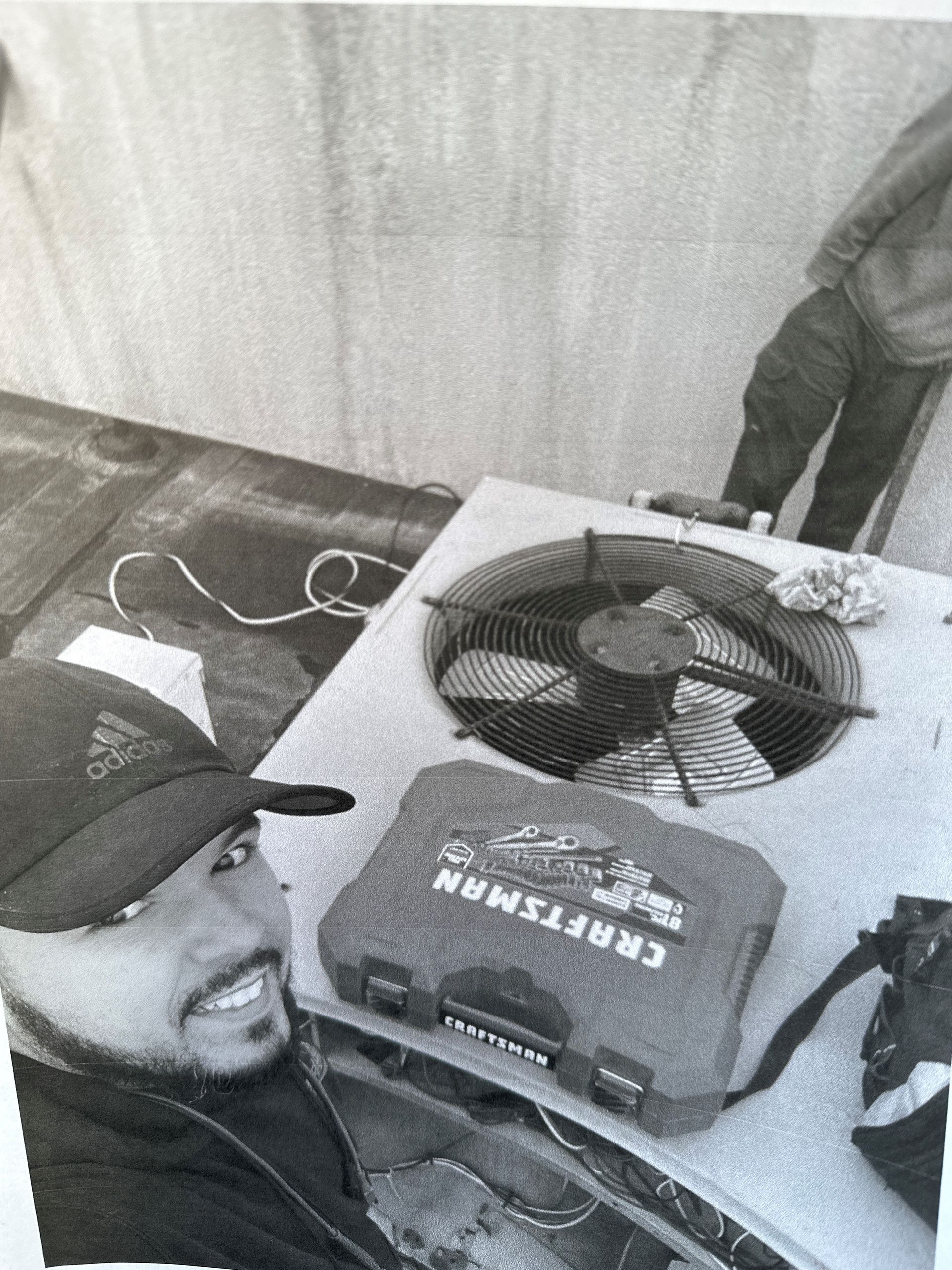 Smiling Man While Repairing Air Conditioner — Lansdale, PA — Abbey Plumbing & HVAC