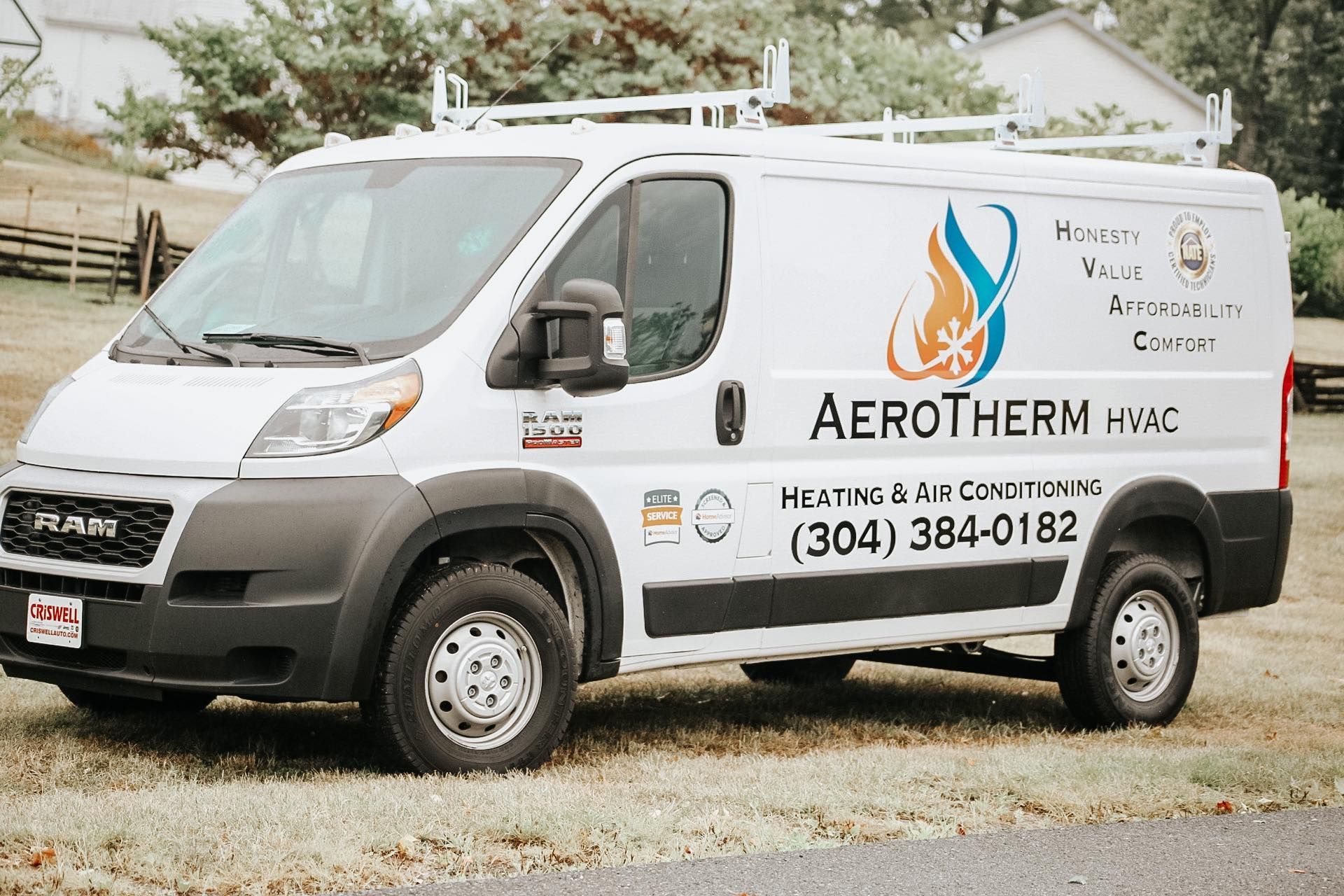 White Aerotherm HVAC service van parked outdoors on a gravel lot