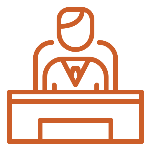 Person sitting behind a desk, likely an office worker, outlined in orange.