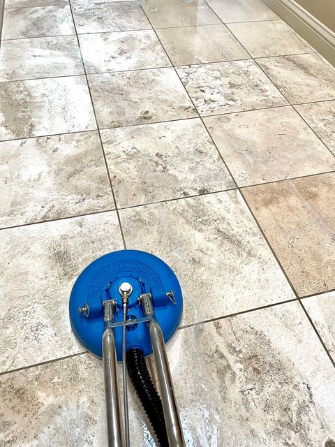 A person is polishing a granite floor with a machine.
