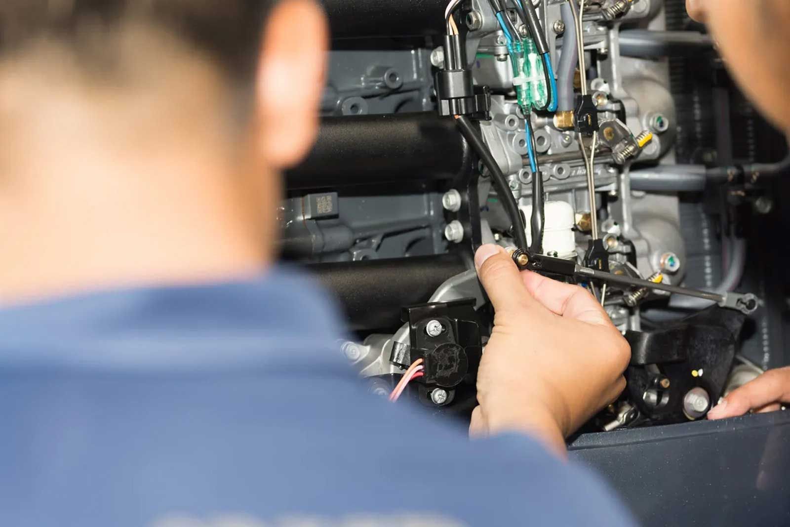 Repairman Adjusting Machine — Auto Electrical Services in Illawarra, NSW