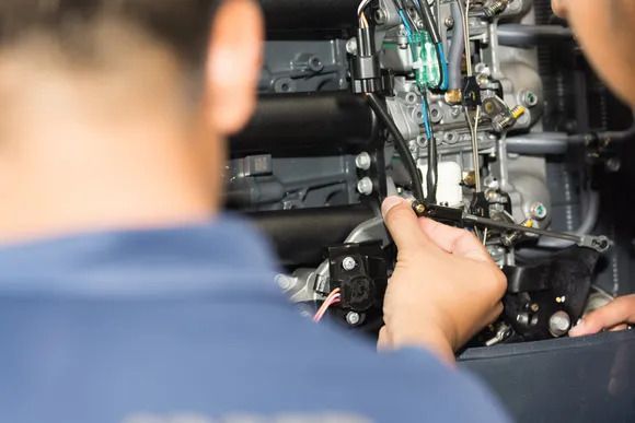 Repairman Fixing Machine —  Auto Electrical Services in Illawarra, NSW