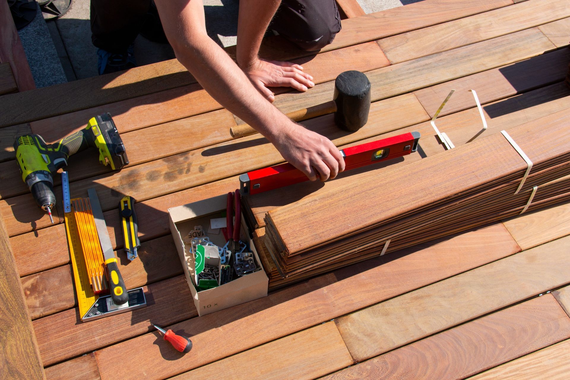 Engineers reviewing construction plans at a desk with a yellow hard hat and measuring tools