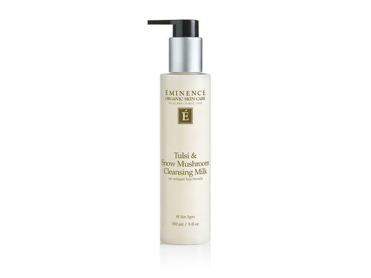 Bottle of cleansing milk with a pump dispenser, white label, silver accents, and black pump top.