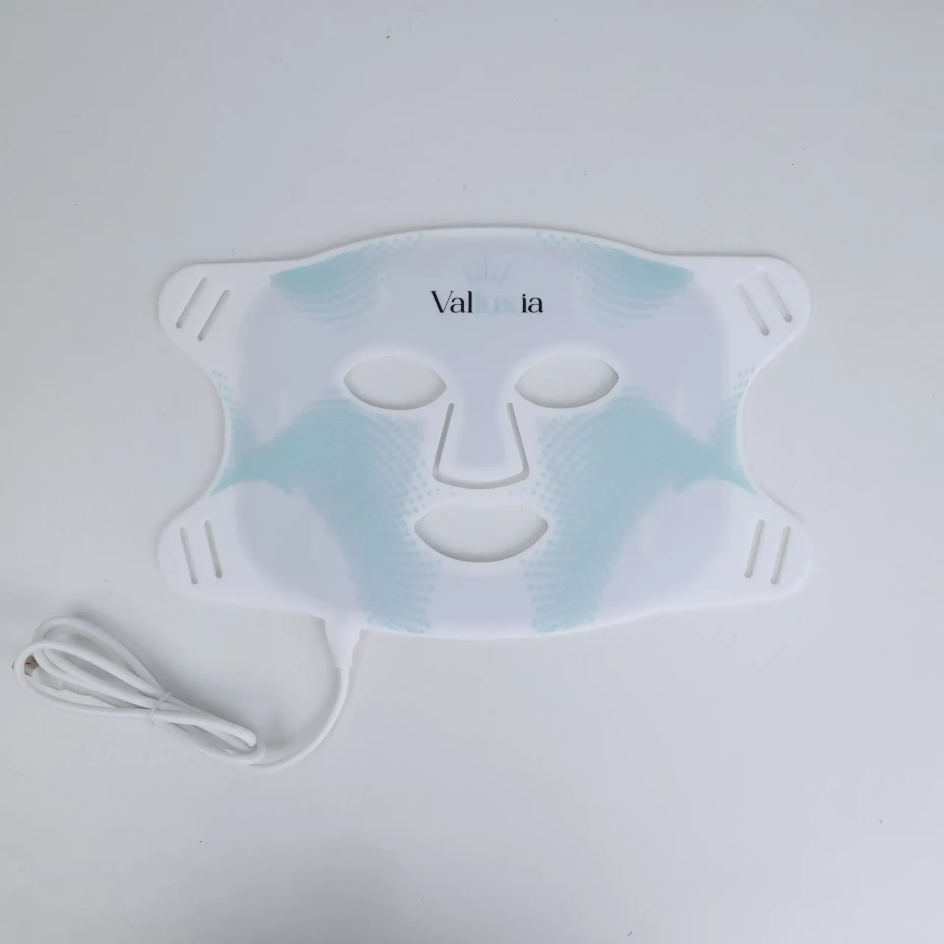 Person wearing a white LED light therapy mask emitting red light. The mask covers the face.