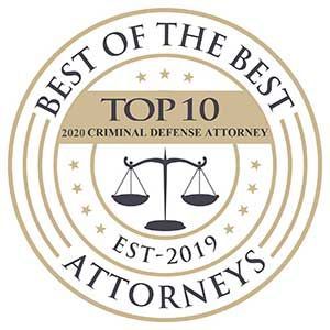 Circular gold-and-black Top 10 criminal defense attorney seal with scales and stars, EST-2019