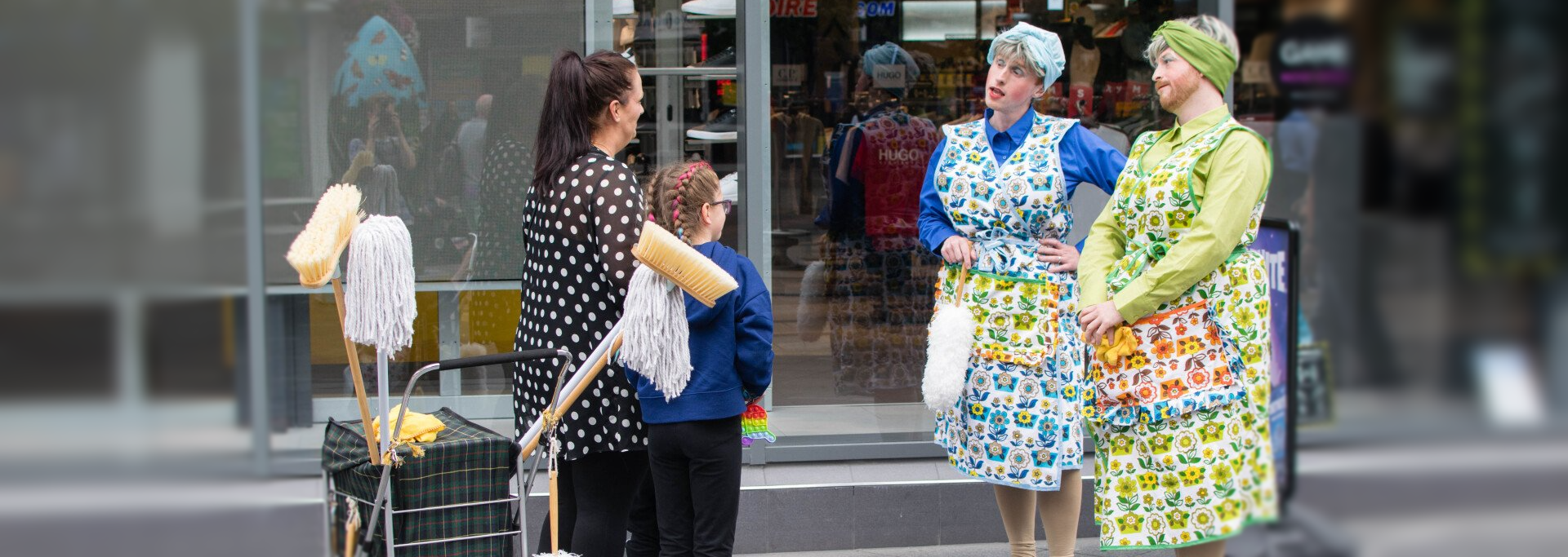 The Dustbusters interacting with a family on city high street